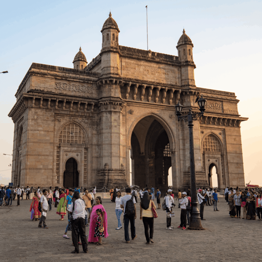 Tourists gathered at the iconic Gateway of India monument in Mumbai at dusk