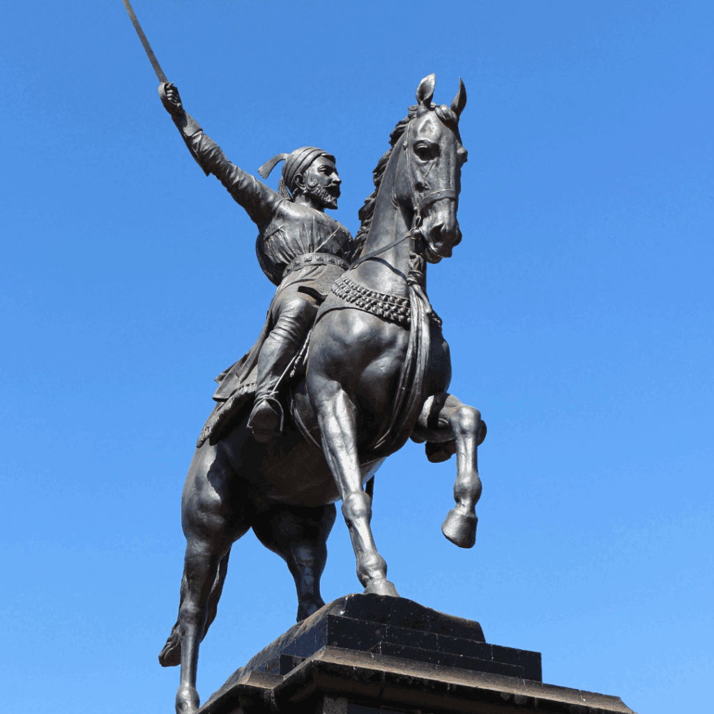 Bronze equestrian statue of Chhatrapati Shivaji Maharaj against a clear blue sky in Mumbai
