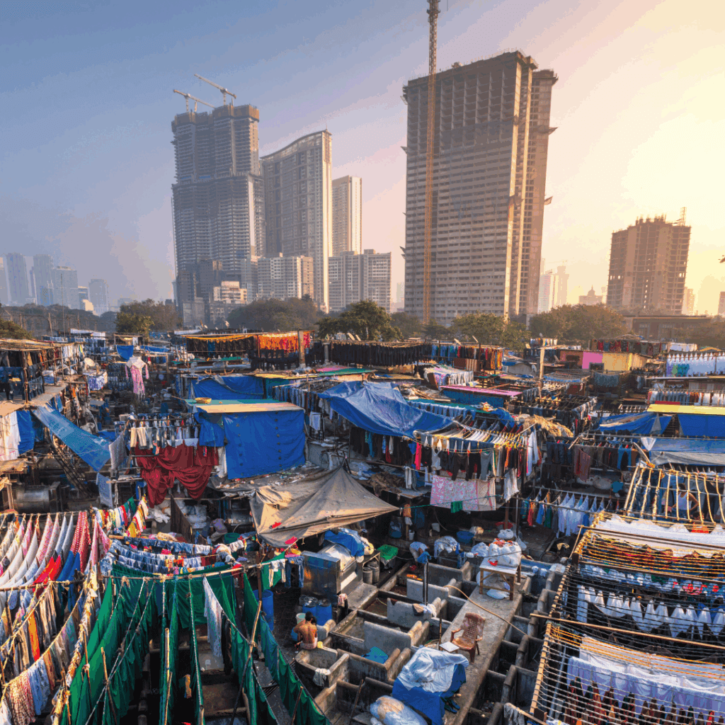 Mahalaxmi Dhobi Ghat in Mumbai with colorful clotheslines and modern skyscrapers in the background.